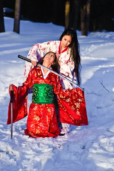 Beautiful brunette girls in a japanese kimono — Stock Photo, Image