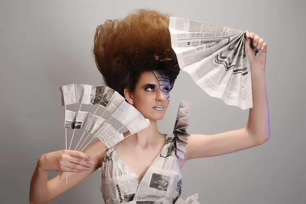 Girl in the newspaper — Stock Photo, Image