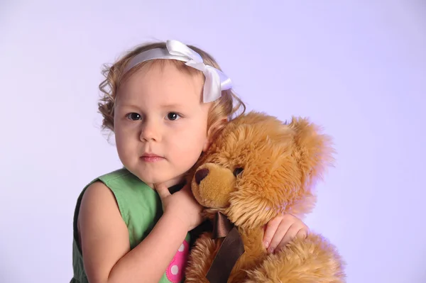 Little girl holding a teddy bear — Stock Photo, Image
