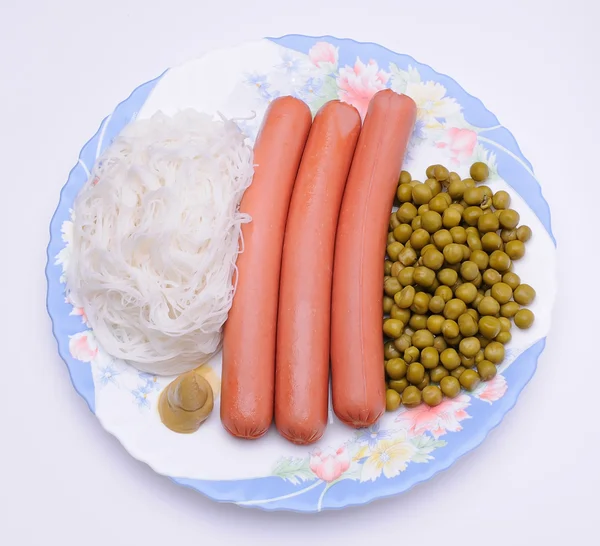 Dish with sausage, noodles and green peas — Stock Photo, Image