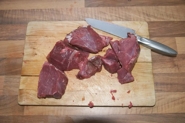 stock image Some pieces of meat and a steel kitchen knife