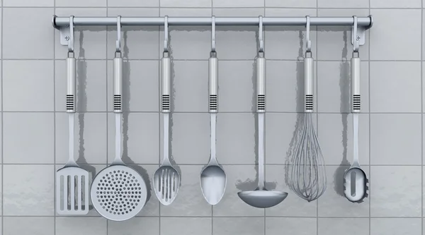 Kitchen utensils on a rack — Stock Photo, Image