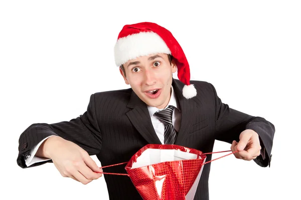 Giovane ragazzo con una borsa rossa in cappello di Babbo Natale — Foto Stock