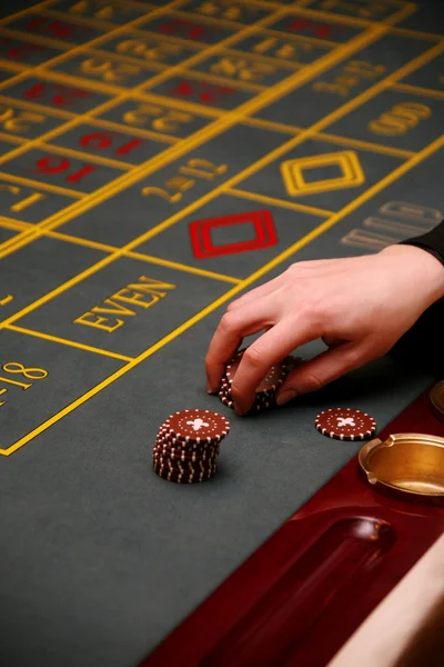 stock image Girl's hand holding chips for game table in a casino