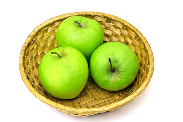 Three green apples on wicker tray — Stock Photo, Image