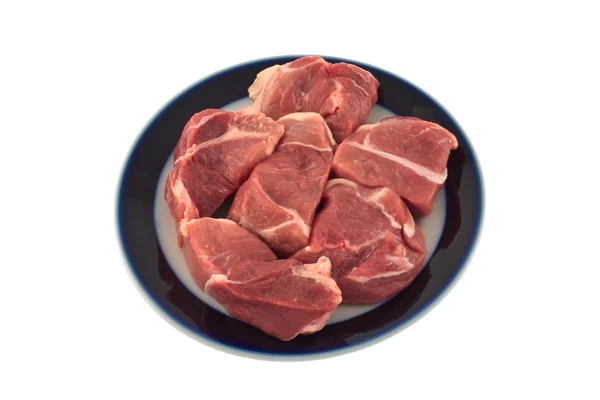Carne crua em uma chapa. — Fotografia de Stock