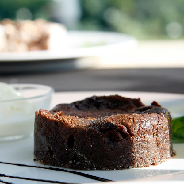 stock image Closeup of chocolate souffle with vanilla ice cream, on a plate