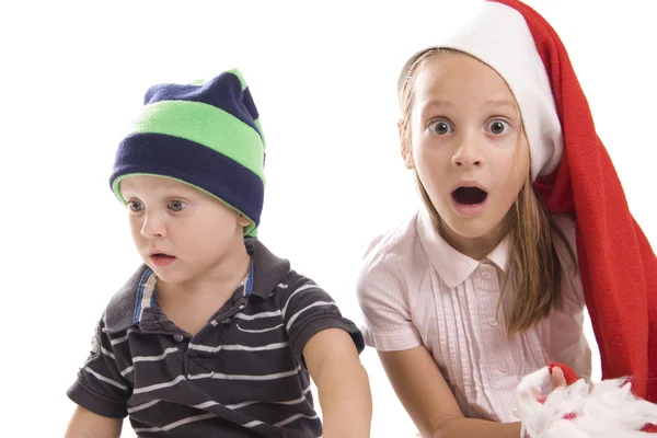 stock image Children in a red and green caps on white background