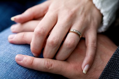 Just married - a closeup of a man and woman hands clipart