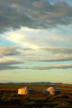 Landscape of gers on the grasslands in Mongolia at sunrise clipart