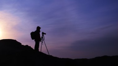 Photographer at sunrise clipart