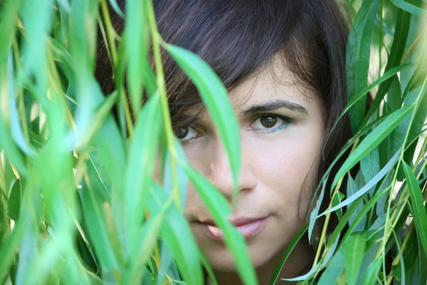 Girl in foliage — Stock Photo, Image