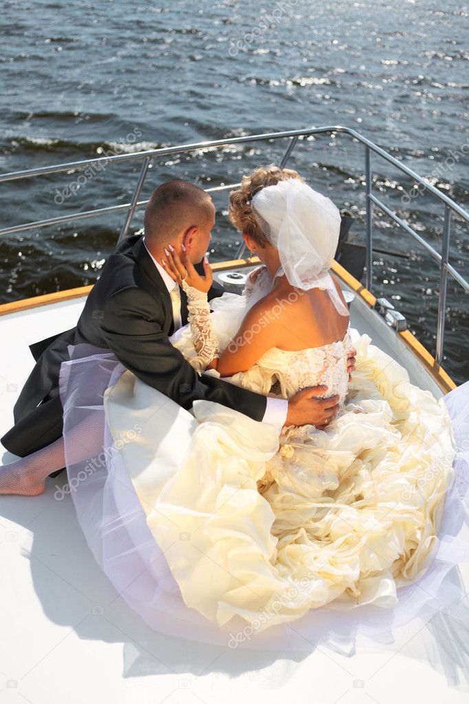 Happy bride and groom on a luxury yacht.