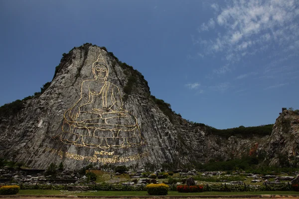 stock image Engraving Sukhothai-style Buddha image on mountain surface