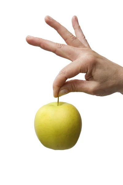 Ruka držící žluté jablko — Stock fotografie
