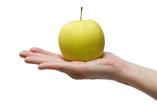 Een gele appel in de hand — Stockfoto
