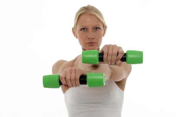Portrait of a young caucasian woman who trains with dumbbells in hand — Stock Photo, Image