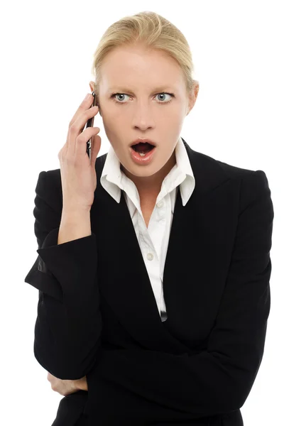 Portrait of a young caucasian businesswoman talking on the phone with aggre — Stock Photo, Image