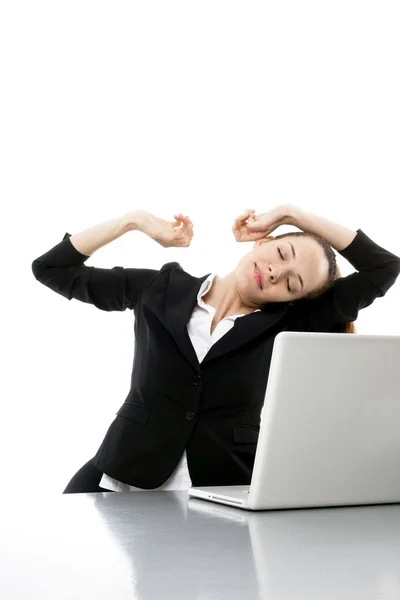 Tired young businesswoman with laptop on white background studio — Stock Photo, Image