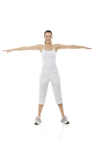 Młoda kobieta robi Gimnastyka na białym tle studio — Zdjęcie stockowe