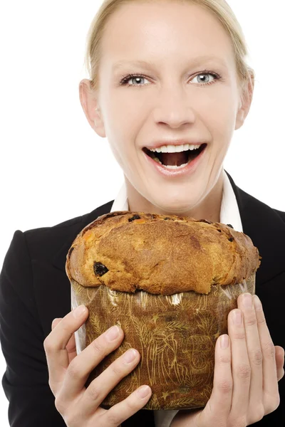Portrait of a young caucasian businesswoman smiling and holding a panettone — Stock Photo, Image