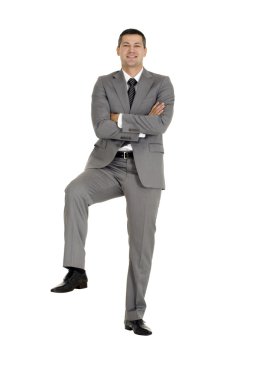 Businessman with a foot on a step clipart