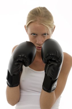 Portrait of a young caucasian woman who does kick boxing with boxing gloves clipart