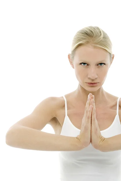 A young caucasian woman dressed in white sitting cross-legged doing yoga — Stock Photo, Image