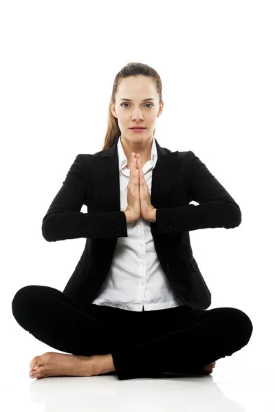 Young businesswoman doing yoga on white background studio — Stock Photo, Image