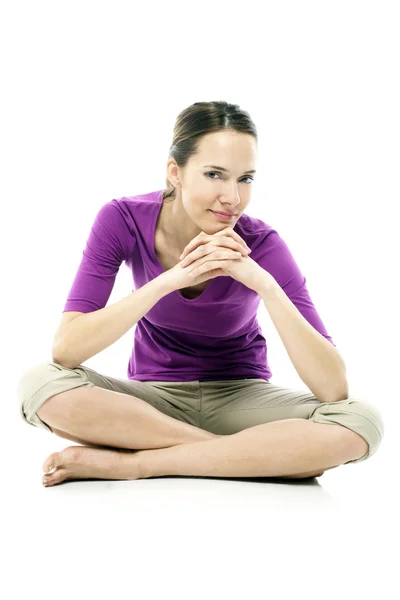 Young woman sitting on the floor on white background studio — Stock Photo, Image