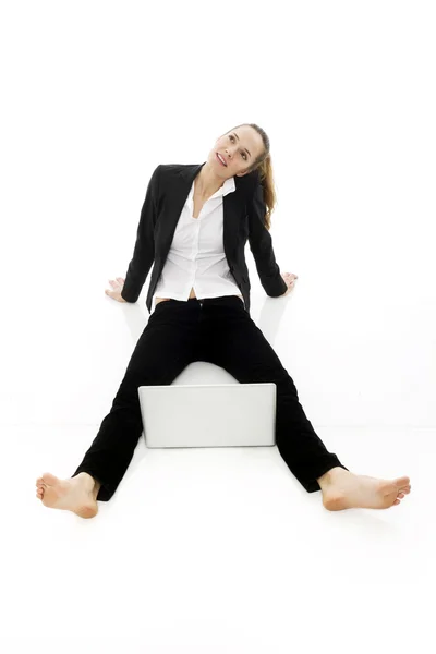 Jonge zakenvrouw met laptop op de vloer op witte achtergrond studio — Stockfoto