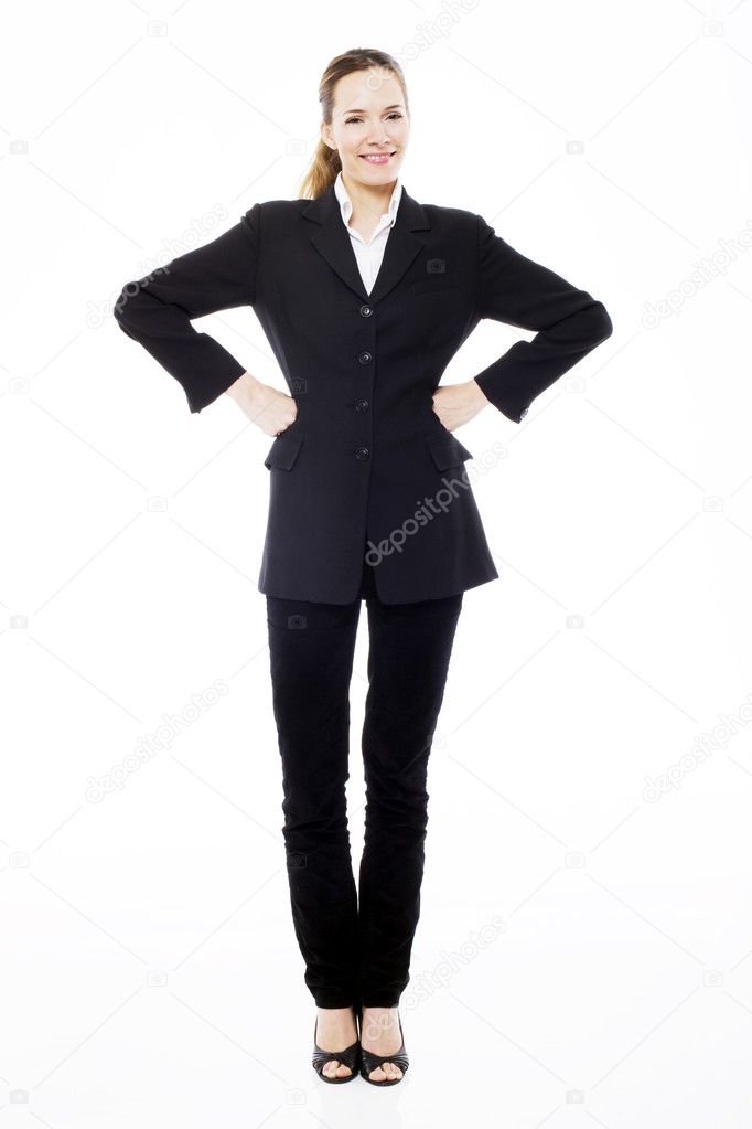 Young businesswoman standing with arms akimbo on white background studio