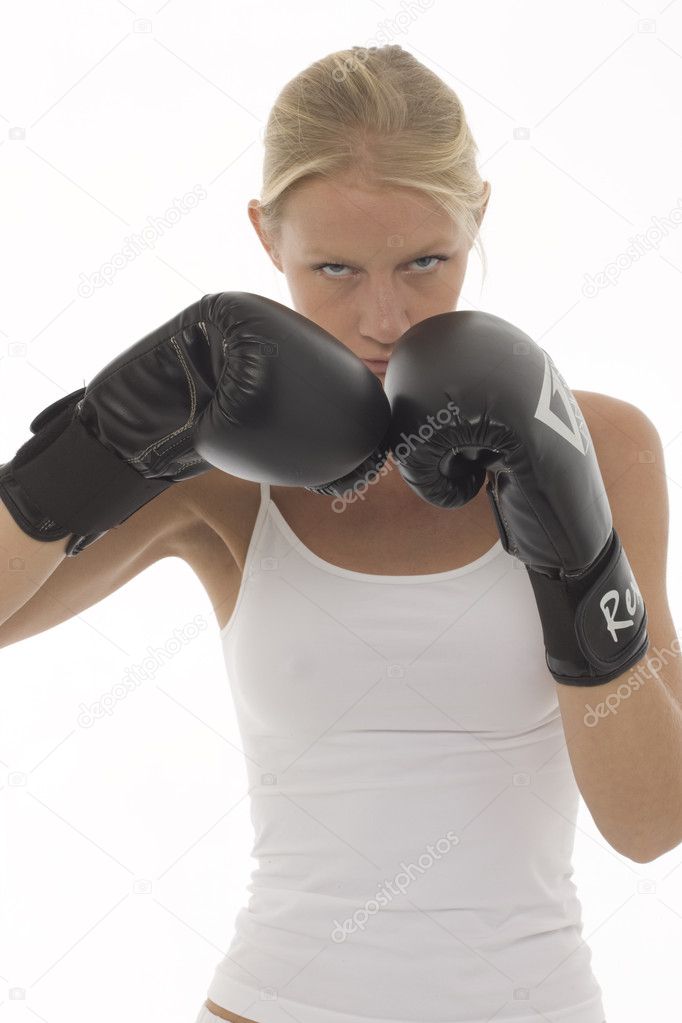 Portrait of a young caucasian woman who does kick boxing with boxing gloves