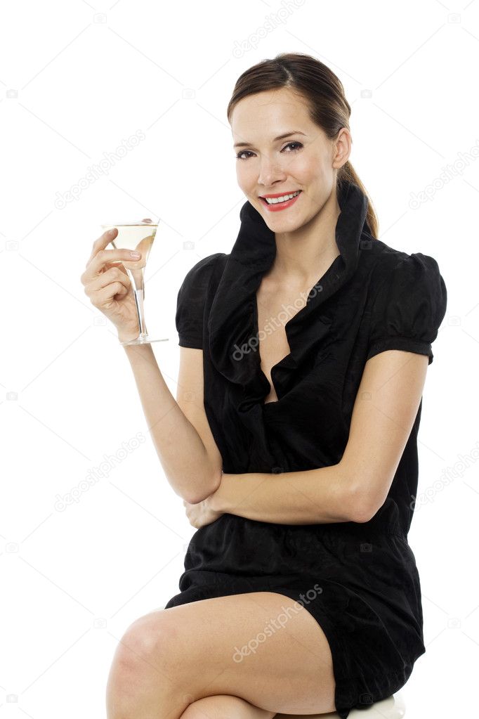 Elegant young woman drinking a cocktail on white background studio