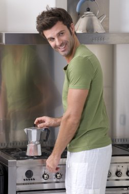 Man in the kitchen preparing coffee clipart