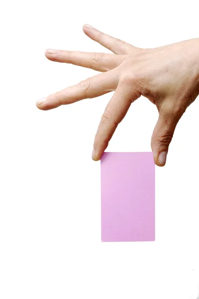 Рука держит розовый лист бумаги — стоковое фото