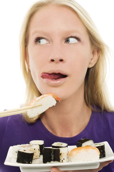 Portrait of a young caucasian woman eating sushi — Stock Photo, Image
