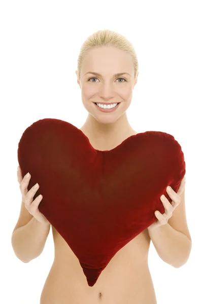 Naked woman with heart-shaped pillow — Stock Photo, Image