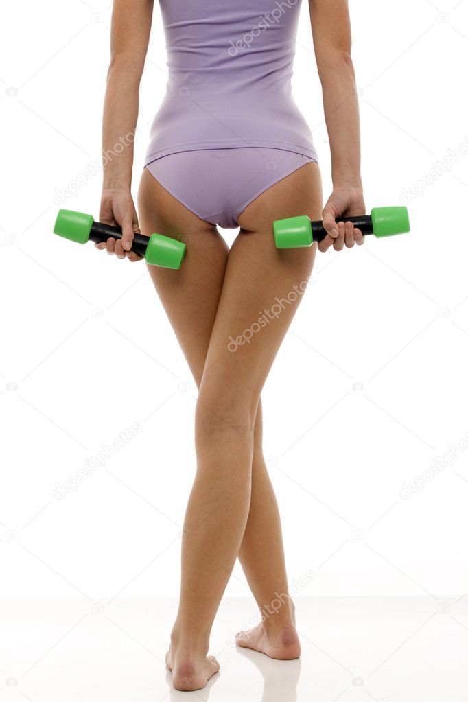 Legs of a young caucasian woman in lingerie back with dumbbells in hand
