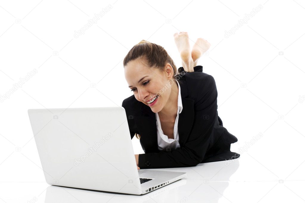 Young businesswoman with laptop on the floor on white background studio