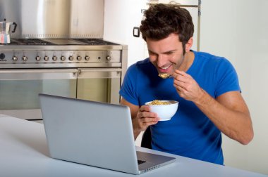 Man in the kitchen with laptop clipart