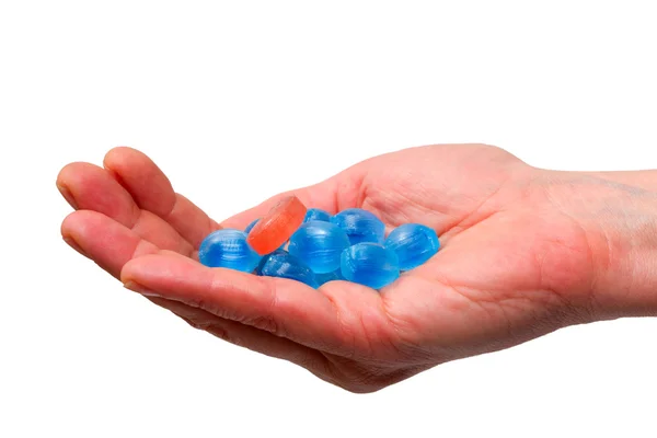 stock image Blue candies in a hand