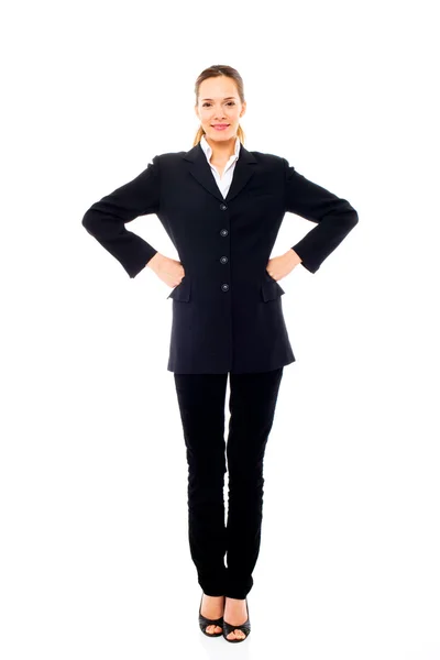 Young businesswoman standing with arms akimbo — Stock Photo, Image