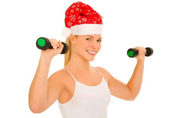 Noel Baba şapkası olan kadın ağırlık kaldırıyor — Stok fotoğraf