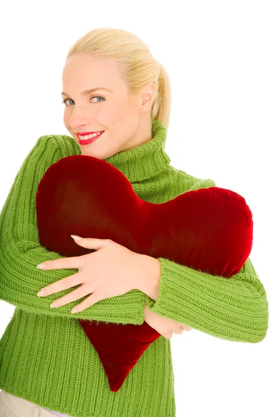 Mujer con almohada en forma de corazón —  Fotos de Stock
