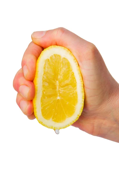 Hand squeezing a lemon — Stock Photo, Image
