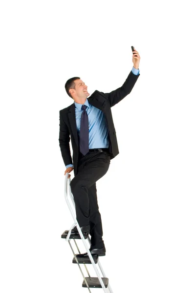 Uomo d'affari su una scala — Foto Stock