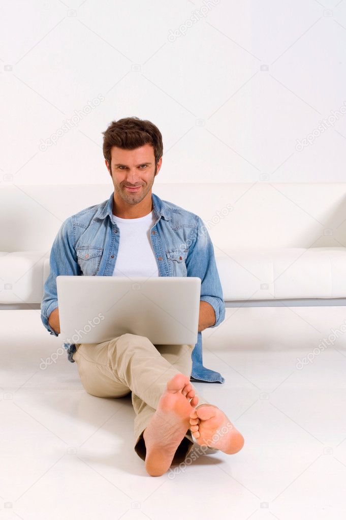 Man sitting on the floor with laptop