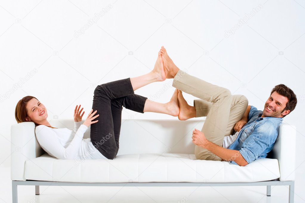 Couple on the couch feet against feet