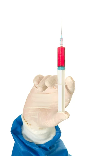 Hand of a surgeon holding a syringe — Stock Photo, Image